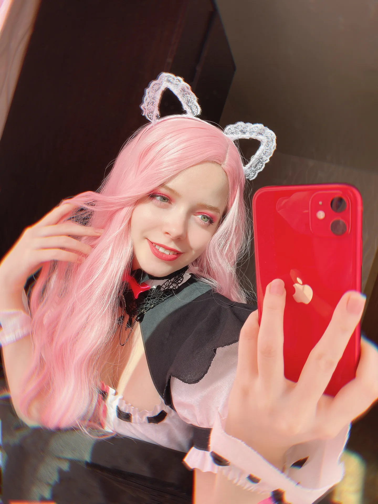 Black-and-white costume with a pink wig