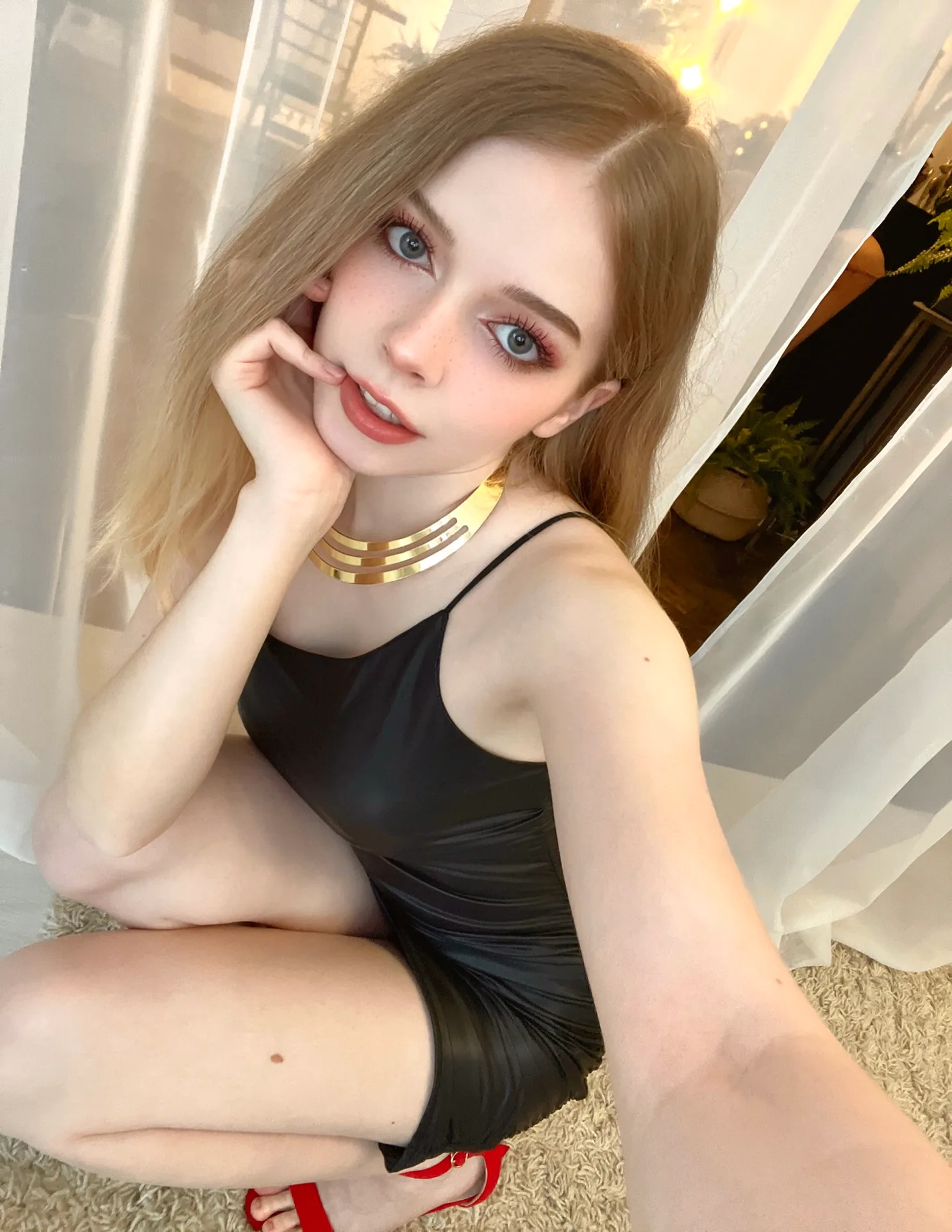 Black outfit by a window
