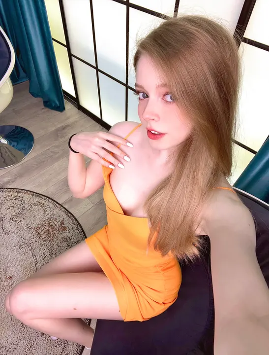 Orange dress on a dark chair