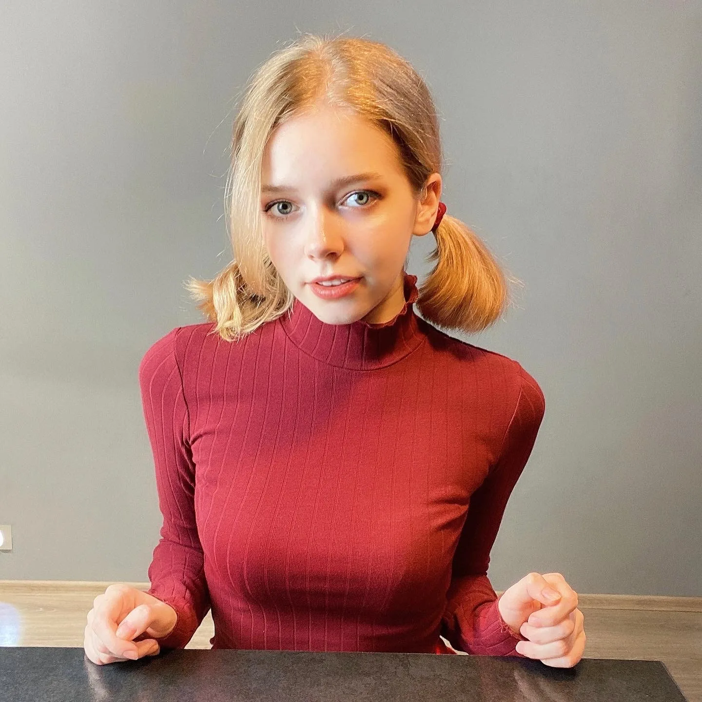 Red turtleneck at a table