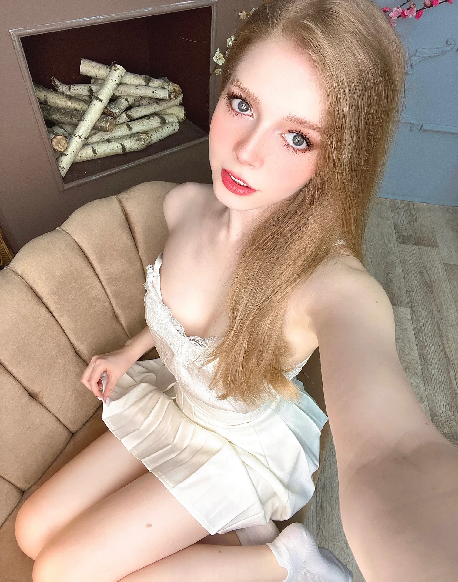 White pleated dress on a beige sofa
